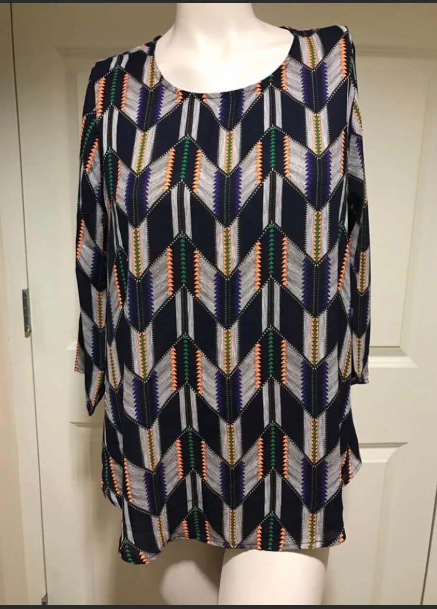 Navy top with white, orange, green geometric pattern