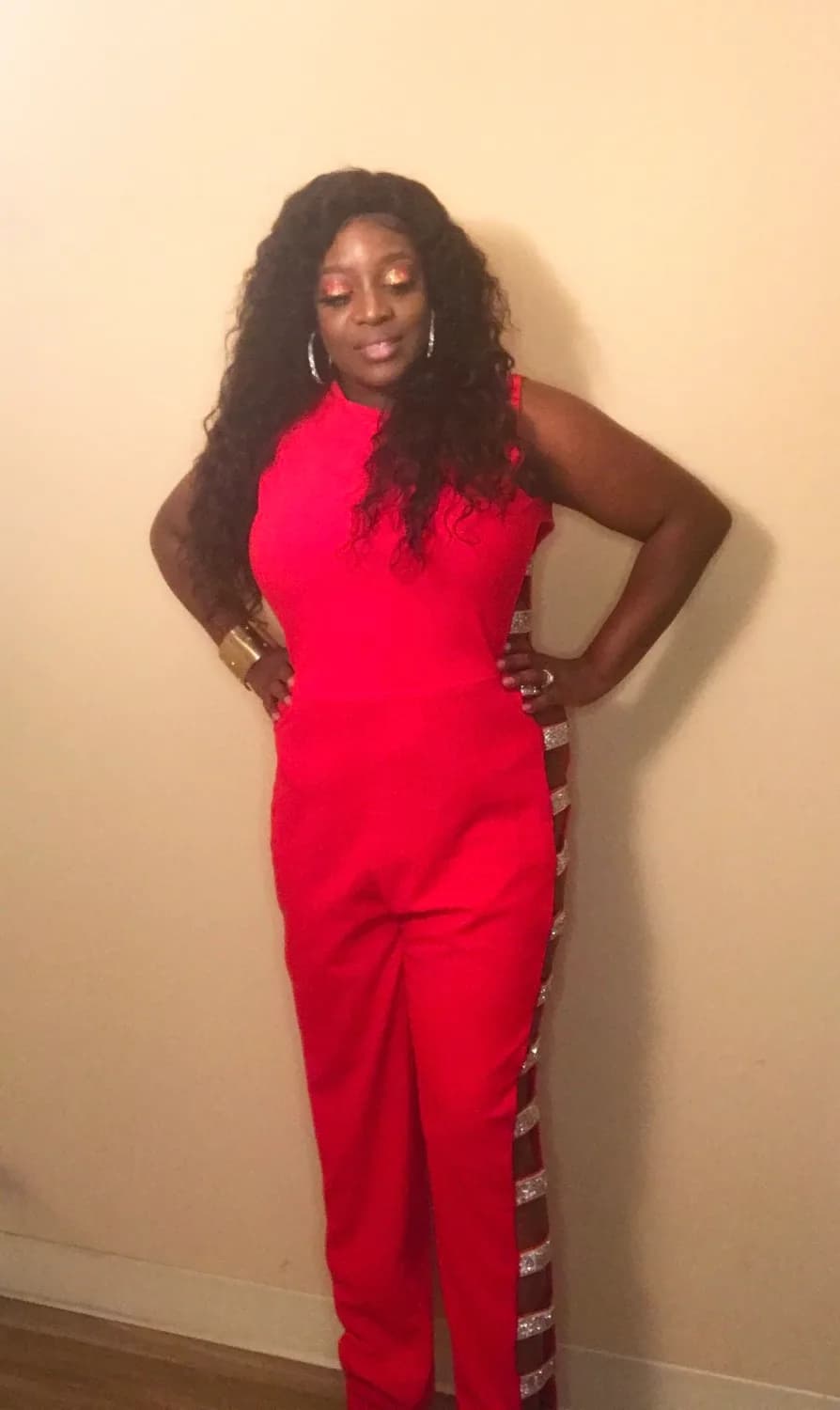 Woman in a red jumpsuit, hands on hips