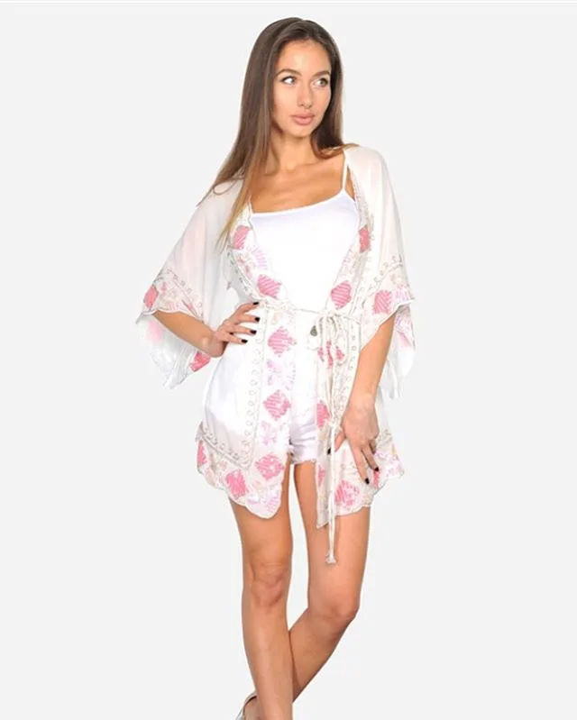 Woman in white romper with pink print and matching robe