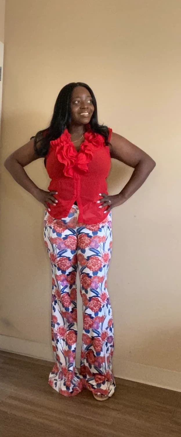 Woman in red ruffled peplum top and patterned pants