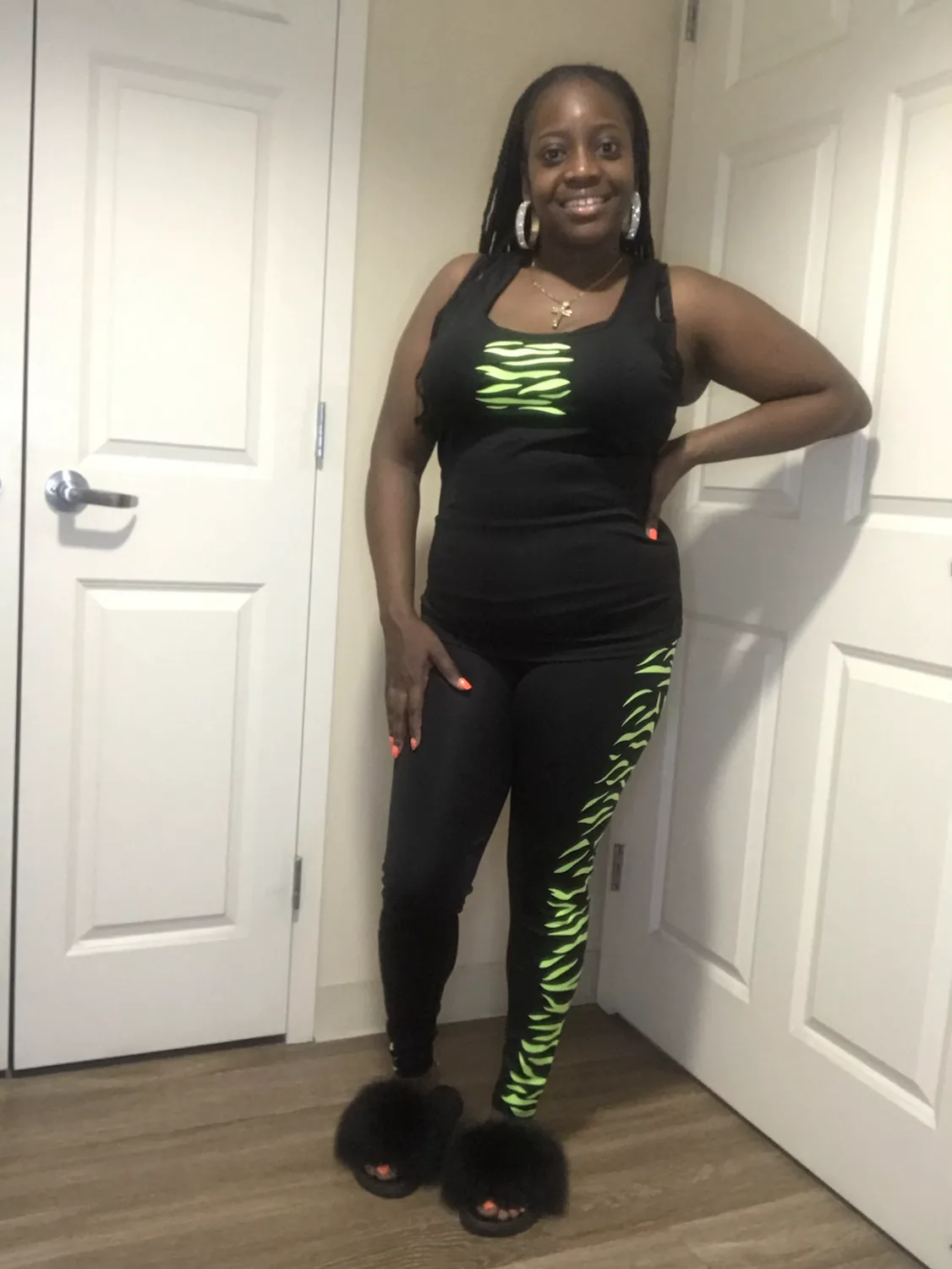 Smiling woman in black and green loungewear set