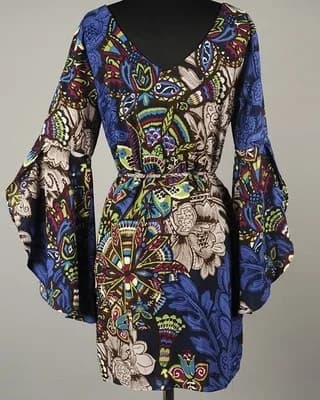 V-neck dress with long bell sleeves and intricate blue floral pattern