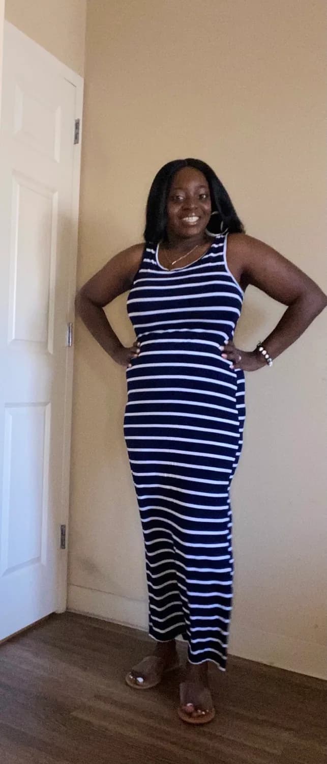 Smiling woman in blue and white striped maxi dress